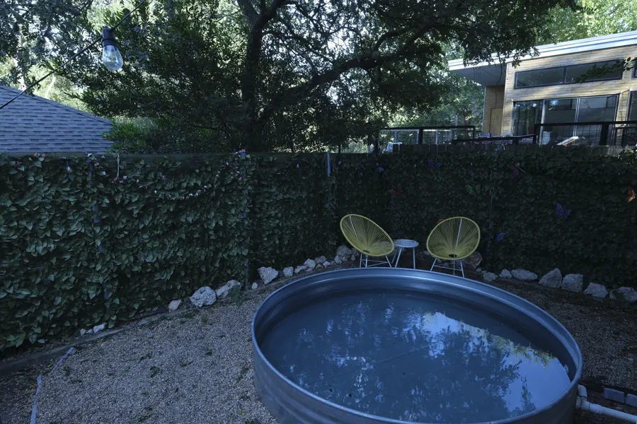 The same backyard as the camera recorded it — dark, flat and green-cast, with the pool water reading as murky.
